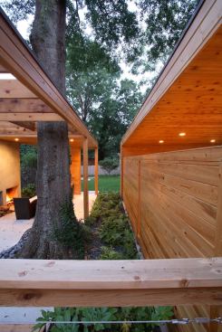 CHDA 2009 – Outdoor Spaces / Merit Award  Architect: Lightroom LLC, Decatur, Ga.; Builder: Pinnacle Custom Builders, Decatur   Local materials and references to Southern vernacular building types inform the sculptural modernism of this cost-efficient backyard complex. The living pavilion's freestanding fireplace makes reference to the chimneys of burned-out country houses that dot the Georgia countryside. Nature intervenes in the form of a stately water oak that anchors a corner of the living area, rising through a roof that dissolves into an open trellis.