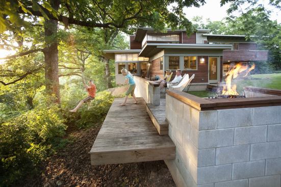 The built-in fire pit area helps mitigate soil erosion on the sloping site.