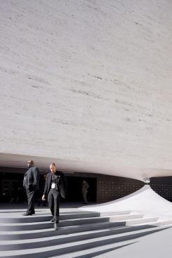The material is printed with a color and texture that mirrors Lincoln Center's ubiquitous travertine, adding to the illusion of a gravity-defying object.