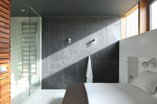 The basement walls and foundation are made of cast-in-place concrete colored to resemble basalt deposits.