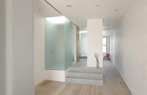 Natural light permeates a skylighted shower with etched-glass walls.