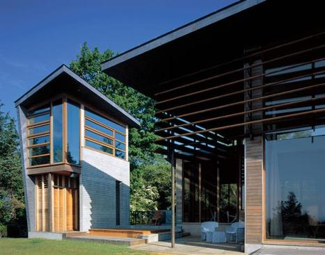 The dining terrace and the art studio enjoy water views. A second bedroom, a laundry room, and a family-room tower define the entry courtyard.
