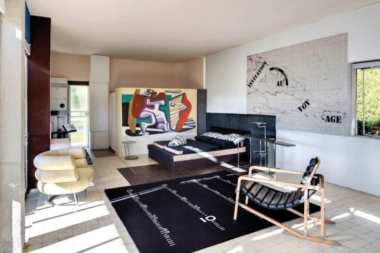The living room, which features a replica of Gray's Bibendum chair and a Le Corbusier's mural