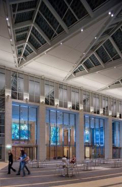 100W PAR38 3000K metal halide surface-mounted downlights integrated into architectural slots in the V-shaped ceiling panels illuminates the floor.