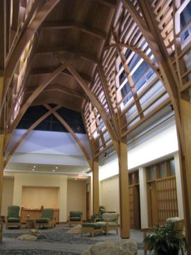 The upper cove, located below the clerestory windows and hidden behind the wood trellis, is a dual switched fluorescent asymmetric linear strip, containing one row of white and one row of blue lamps.