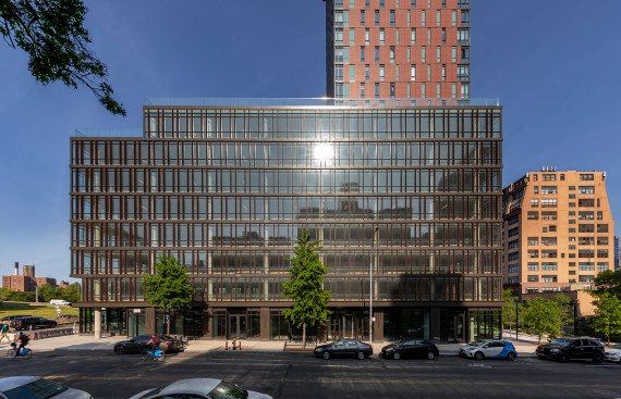The terracotta fins of glass office building make a visual connection with the residential tower