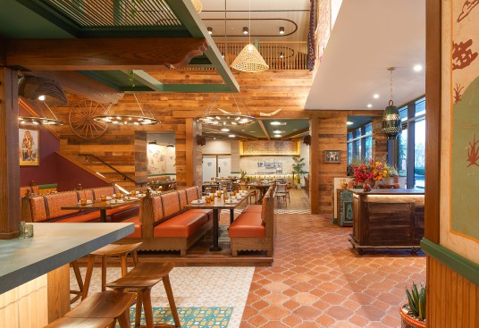 Upon entry, guests will notice an expansive dining room decorated with antique and vintage goods, along with basket lights integrated throughout. 