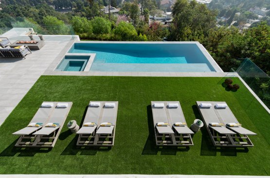 Aerial view of Los Tilos Hollywood Hills modern house with terraces from rooftop to pool.