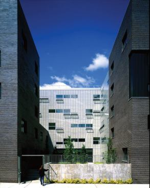 A+view+between+two+of+the+residential+volumes+affords+views+to+the+academic+bar+building+beyond.+