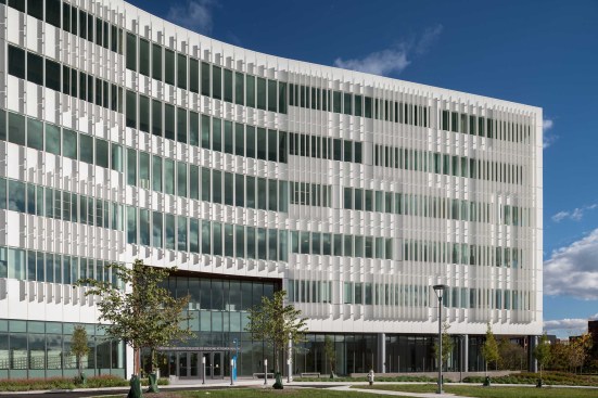 The building's west side façade and entry relates to the river on the east side – the vertical fins, or shading device, represents a rippling effect of the river and changes pattern as the time shadows of sun reflection hits the building.  The also serve as vertical sunshades to control the emittance of light into the building. People inside have less glare.
