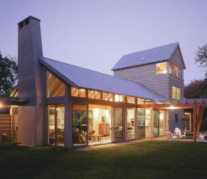 The rear of the house is nearly transparent. In place of gutters, crushed stone trenches channel water to adjacent wetlands. A study and a daughters bedroom occupy the second and third floors of the tower, respectively.