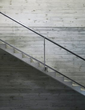 Board-formed concrete lines the interior stairwell.