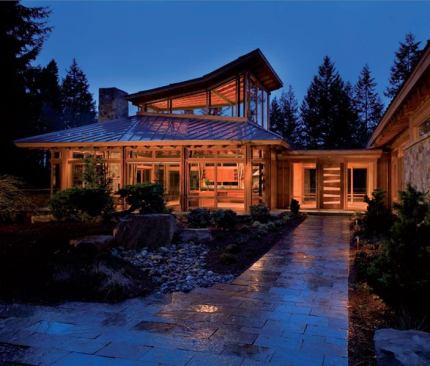 With its glass walls, off-center hip roof and soaring monitor, this house's great room wing cuts a dashing figure.
