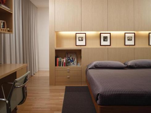 At the master bedroom, the millwork volume becomes a headboard/storage unit.