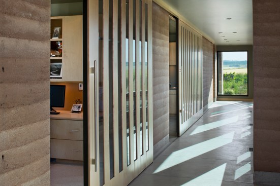 Interior, horizontal, looking down hallway with slatted rolling doors, Earth Wall II, Squirrel, Idaho; Ward + Blake Architects