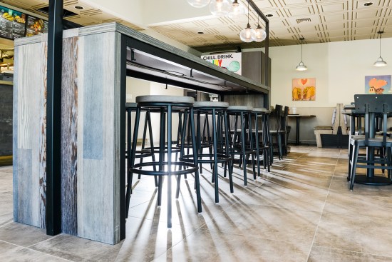 The washable Ceilume ceiling panels extend over the food preparation areas to visually unify the dining areas and exposed kitchens, part of Taco Bell’s Modern Explorer concept.