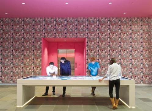 The lobby features an interactive table that visitors can use to explore the museum's exhibitions and permanent collection.