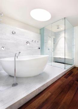 The master bath features a generous helping of marble, with port holes cut in the wall.
