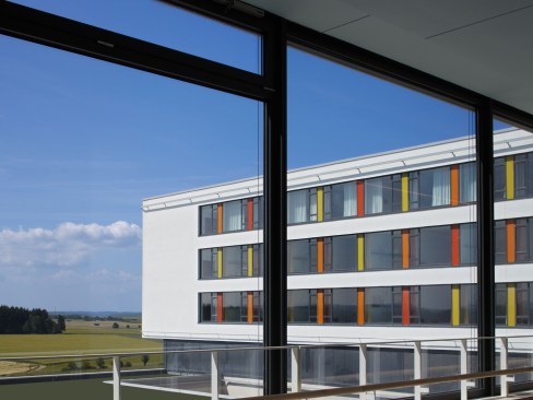 he+exterior+stays+true+to+German+modernism+and+features+simple+forms%2c+cubic+shapes%2c+and+a+white+facade+with+yellow%2c+red+and+orange+accents.