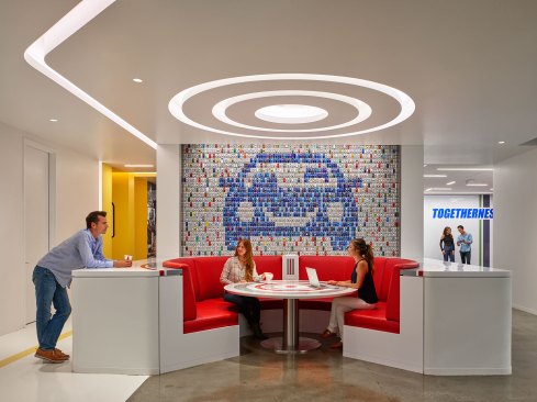 Collaborative work areas are illuminated using ambient coves to provide visual comfort.