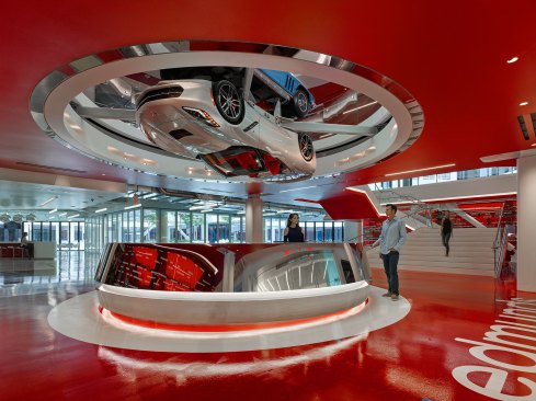 The reception area is treated with a mirror-polish stainless finish and uses LED strips and concealed uplights and sidelights to illuminate the classic Corvette mounted on a slow-moving turntable above.