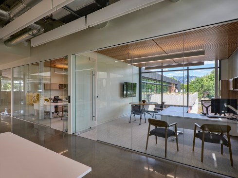 A glass and louver system on the existing 2nd floor allow natural light to flow into executive suites and to bring levity to the building’s volume.