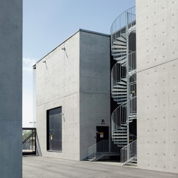 A central court between the structures, and behind the fence, allows for secure vehicle access for service.