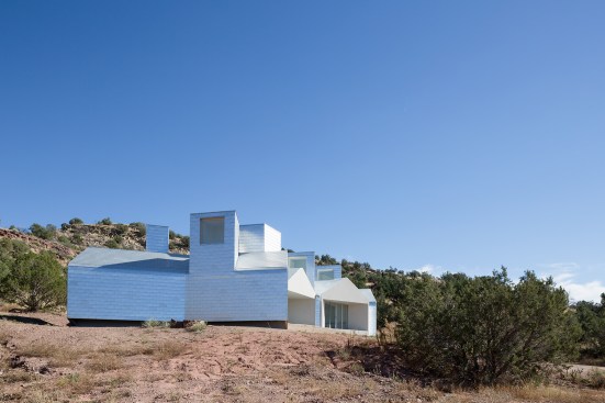 It was built with structural insulated panels from R-Control Systems and clad in Zappone aluminum shingles, which act as a heat sink