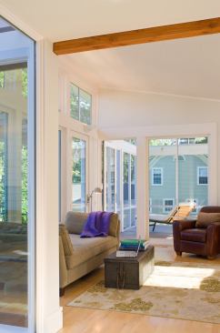 The living room addition extends into a screened porch.