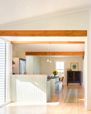 Exposed wood beams do the structural work of former bearing partitions.