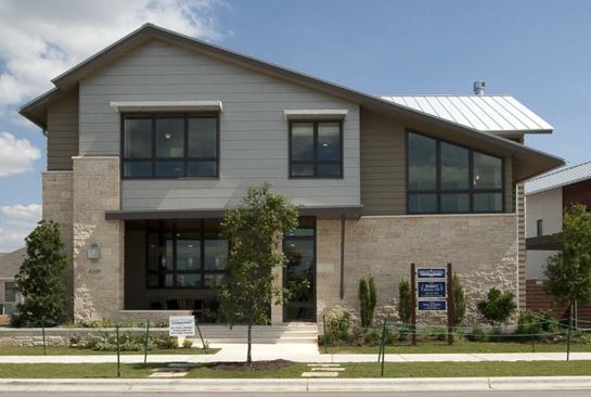 The exterior of this site-specific house features a mixture of smooth-cut and chopped fossil limestone masonry and James Hardie fiber-cement lap siding.