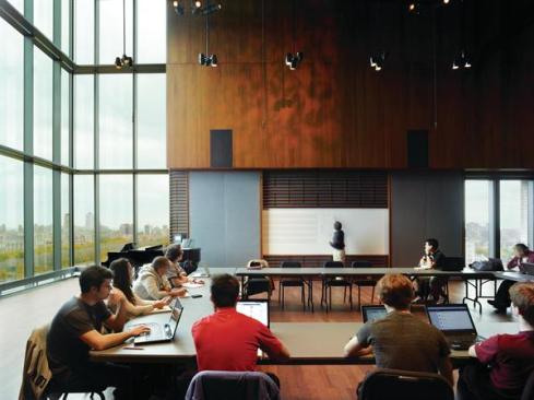 The+penthouse-level+performance+hall+in+the+tower+can+serve+as+a+classroom%2c+a+rehearsal+space%2c+or+a+music+venue.+Micro-perforations+in+the+walnut-lined+walls+expose+acoustic+material+that+absorbs+sound.