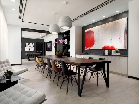 Large custom art pieces dispersed throughout the amenity levels cohesively tie in with the raw materials and furnishings.