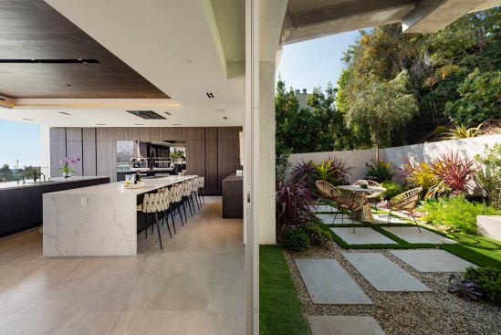 Modern home outdoor terrace dining with view of the Hollywood sign.