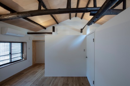 Upstairs bedroom view. These partition walls' height was designed to make the bedroom space airy while providing privacy.