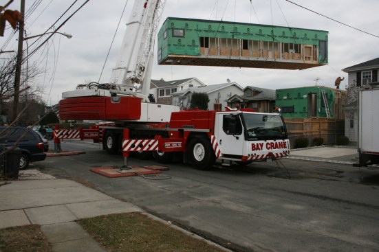 Prefab modules being set by crane.