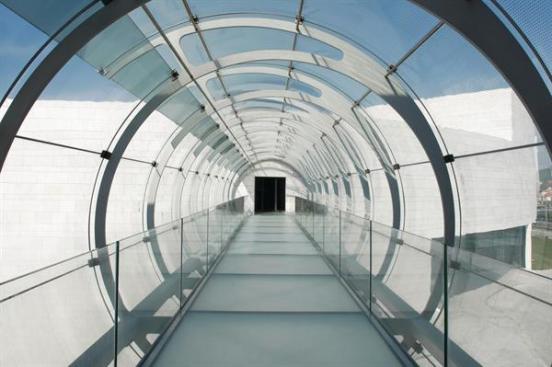 An indoor-outdoor garden brings greenery into the stone complex.