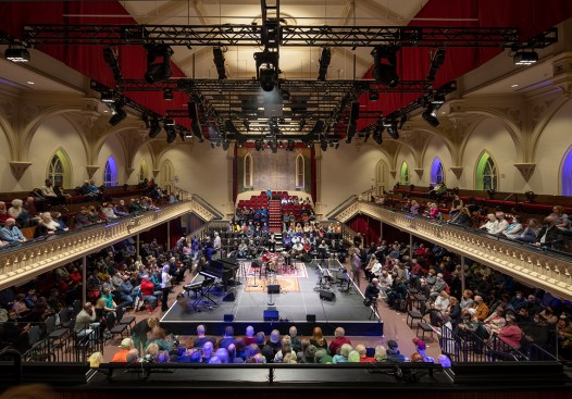 View of the Great Hall looking north. The portable stage allows for various configurations, including the center stage layout seen here, which provides a very intimate performance. The new lighting grid allows for maximum flexibility and houses a large screen that can be utilized for film screenings or presentations.
