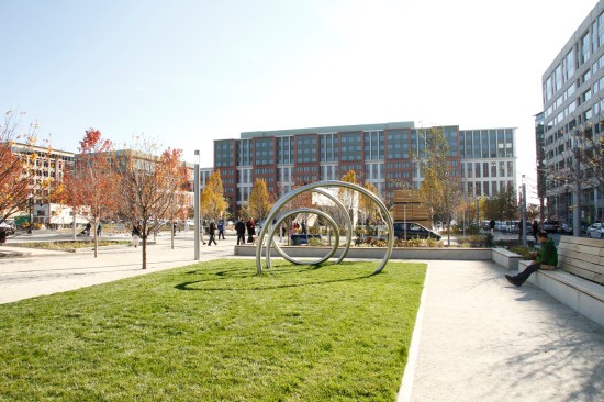 Benches line unprogrammed green spaces that can be used for play areas and public events. The park features three sculptures by artist David Hess.