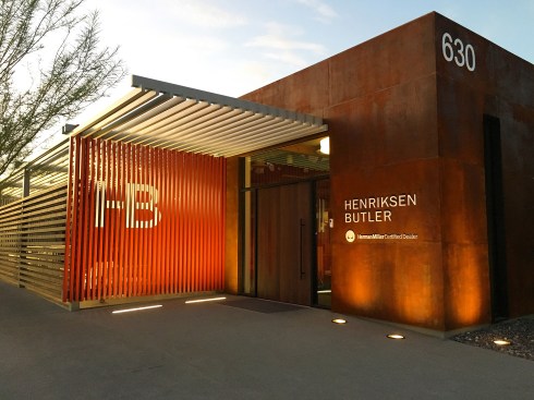 The HB logo / brand is introduced to the main facade at the entry piece. Horizontal steel trellis members turn vertically, and are painted red displaying the masked out and painted white HB logo that becomes an additional art piece within the larger Arts District.