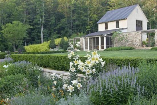 The formal gardens coexist peacefully with the property's wilder edges.
