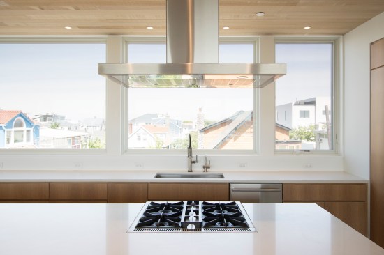 Large windows looking over the neighboring houses were used in place of upper cabinets 