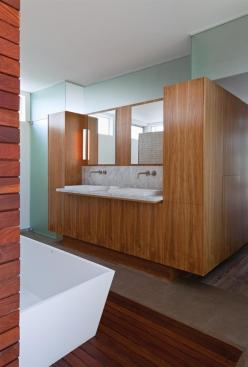 A walnut millwork box separates the bath from the master bedroom.