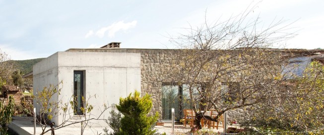 barbaros house with a mountain behind.