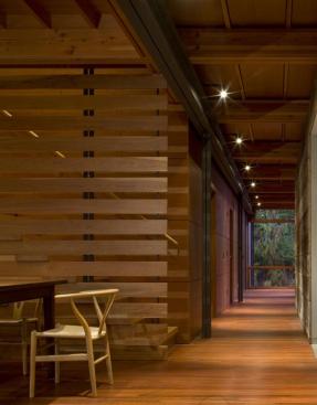 A stair assembly of solid cherry slats and thick fir treads leads to an office loft, which creates an intimate dining space below.