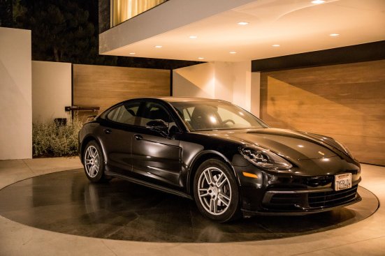 Luxury custom design modern home gated driveway with auto turntable for car parking.