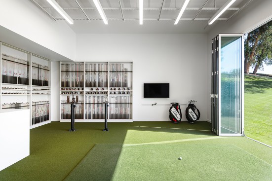 Club fitting studio with accordion doors to the driving range