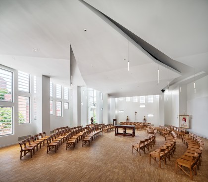 The faceted terracotta facade windows allow natural light into the sanctuary during the day and glow from within at night.