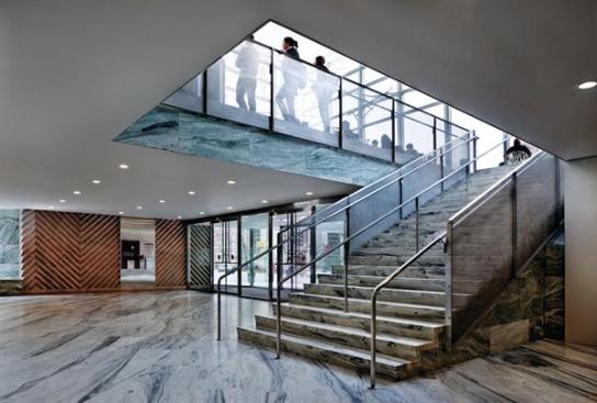 The stone-clad lobby features wall panels that mimic the diagonal etching on the fa?ade panels.