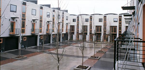 Colored pavers delineate the car court and common space between each set of buildings.